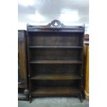 An Arts and Crafts carved oak open bookcase