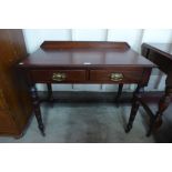 A late Victorian mahogany two drawer writing table