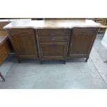 A large French carved oak breakfront sideboard