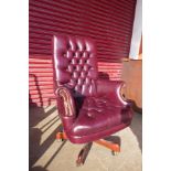 A Chesterfield style burgundy leather revolving desk chair