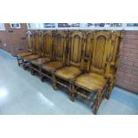 A set of twelve Carolean style oak dining chairs