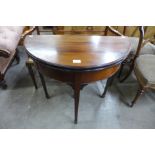 An Edward VII mahogany demi lune fold-over games table