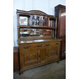 An Arts and Crafts carved oak mirrorback sideboard