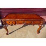 A Chippendale style hardwood three drawer library desk