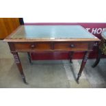 A Victorian mahogany and green leather topped two drawer writing table