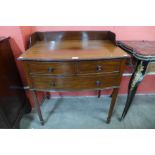 An Edward VII mahogany three drawer bow front side table