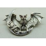 A silver 'Bat in the Moon' brooch with ruby eyes