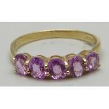 A 9ct gold and five stone pink sapphire ring, approximately 1ct total weight, 1.9g, P/Q