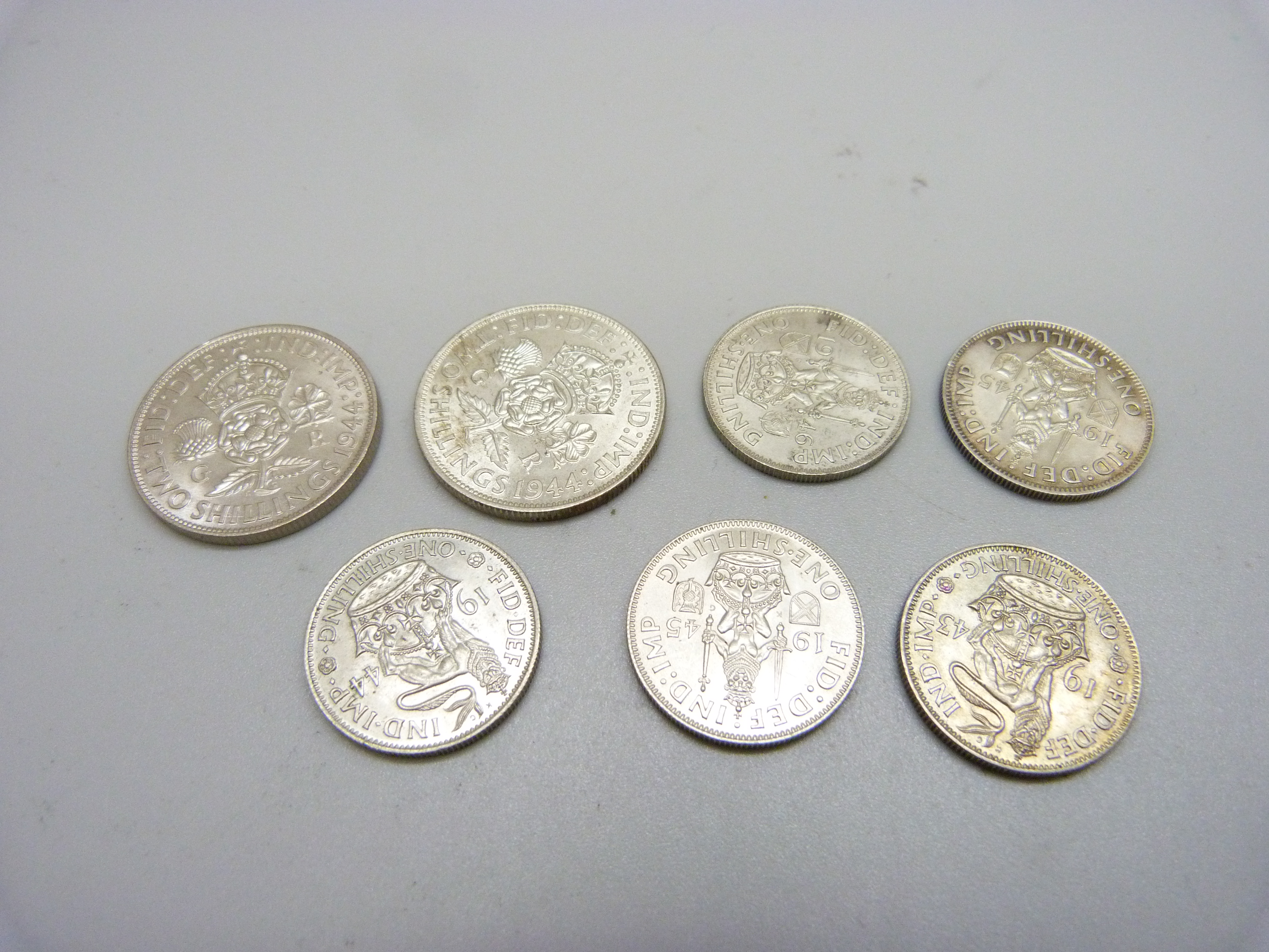 Seven coins; two 1944 shillings and five one shilling 1943, 1944, 2x 1945 and 1946 - Image 2 of 2