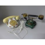 Two vintage rotary telephones; Royal Albert Old Country Roses and one other, (with cables)
