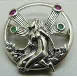 A silver ruby and emerald set fairy brooch