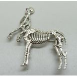 A silver skeleton/horse brooch, height 55mm