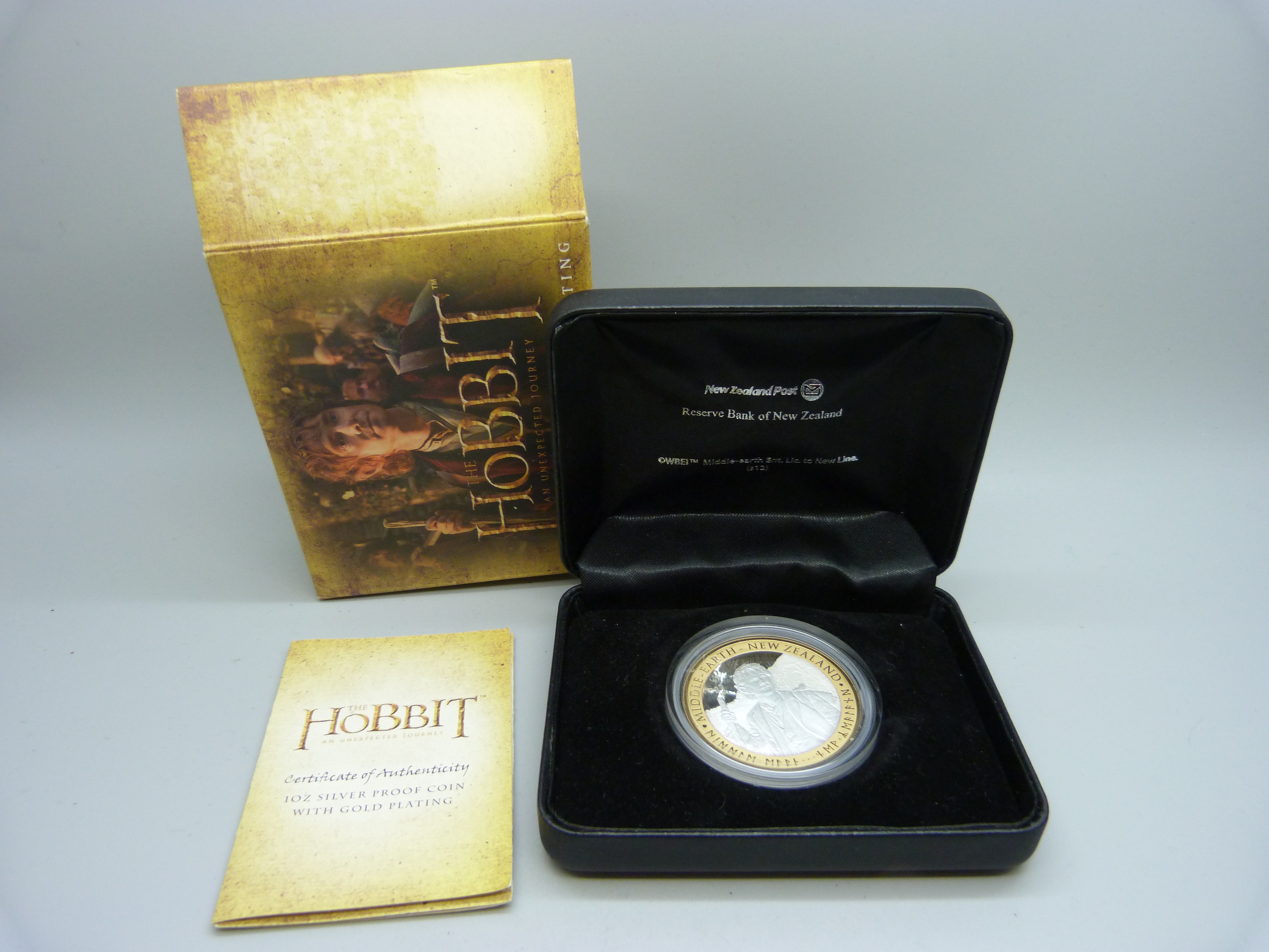 A silver proof The Hobbit 1oz coin, boxed