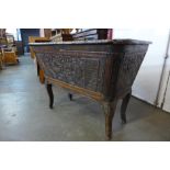 An unusual extensively carved 19th Century French oak sarcophagus shaped coffer