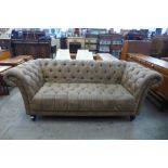 A brown faux leather Chesterfield settee