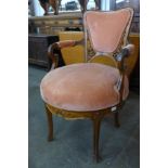 A French Art Nouveau carved walnut and peach fabric upholstered revolving armchair