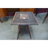 An Edward VII carved oak occasional table