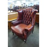 An oxblood leather Chesterfield wingback armchair