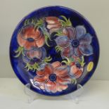 A Moorcroft anemone charger, 25.5cm and display stand