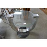 A circular chrome and glass coffee table