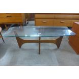 A teak and glass topped coffee table