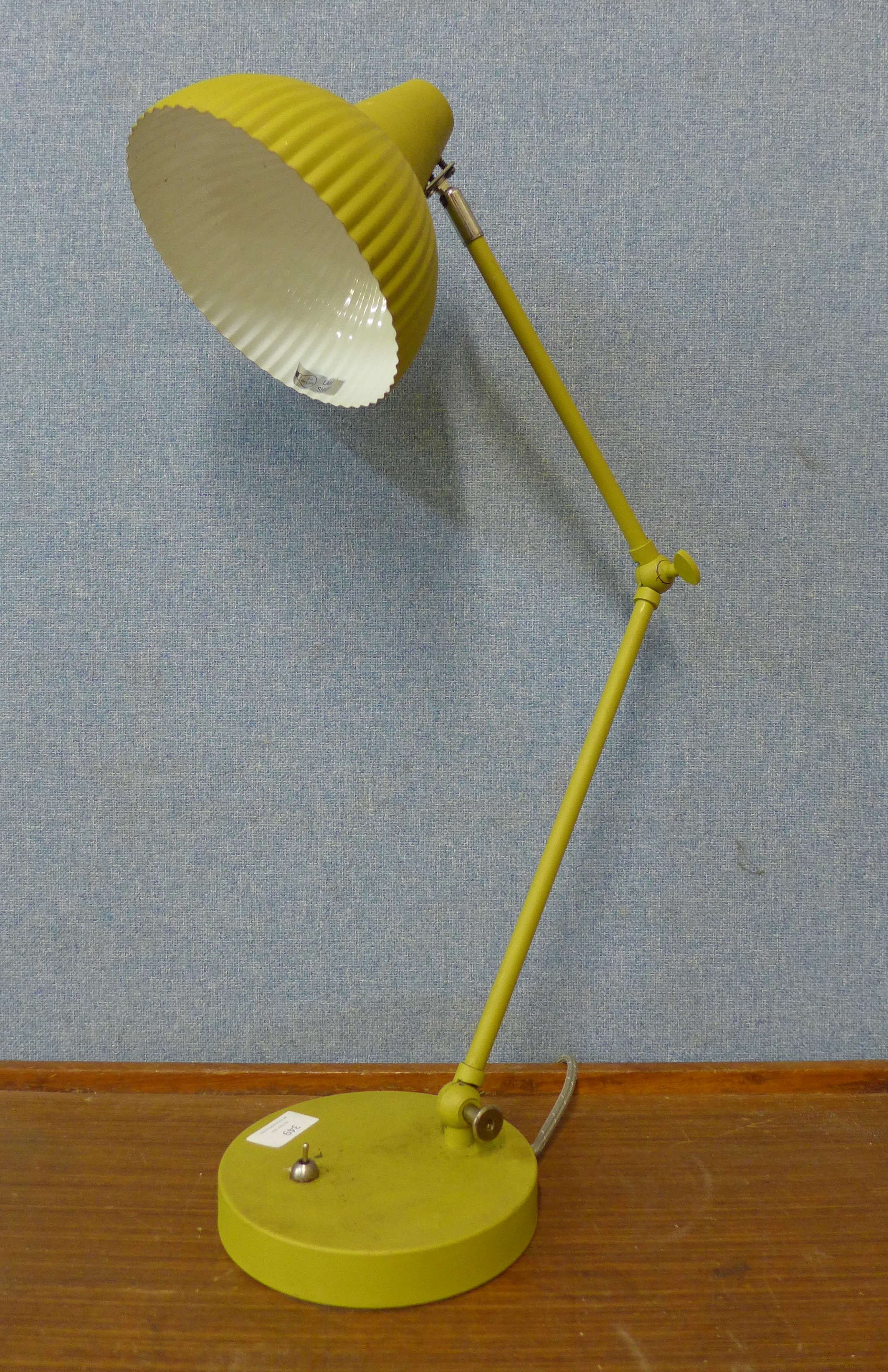 A green metal anglepoise desk lamp