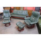 A Norwegian Ekornes beech and green leather Stressless five piece suite, comprising; settee, two