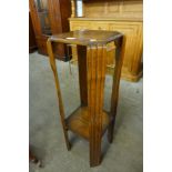 An Art Deco oak jardiniere stand