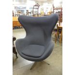 An Arne Jacobsen style chrome and grey fabric revolving egg chair