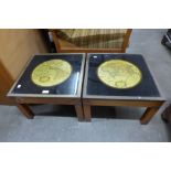 A pair of teak and brass mounted occasional tables, inset with maps of the world