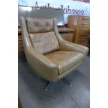 A chrome and tan leather revolving armchair