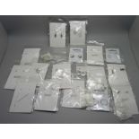 A collection of silver earrings, packaged