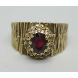 A 9ct gold ring with bark effect design and garnet cluster, makers mark S&Co, shank split, 4.8g, P