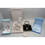 A collection of silver jewellery, pendants and charms, etc.