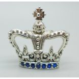 A silver crown brooch set with blue stones, marked sterling