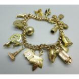 A 9ct gold bracelet with heart padlock fastener and 19 charms including a 9ct gold Georg Jensen car,