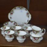 A Royal Albert celebration six setting tea set lacking one cup, with sugar and milk jug