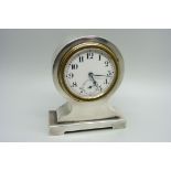 A silver desk clock, with Swiss movement