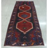 A Persian red ground Hamadan runner rug, 115 x 298cms