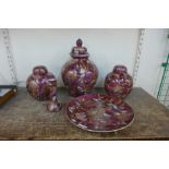 Three Chinese scarlet porcelain jars and covers, a plate and candlestick