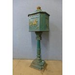 A cast iron freestanding letter box, with key