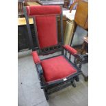 A 19th Century American ebonised and fabric upholstered rocking chair