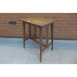 An Arts and Crafts oak occasional table, manner of Liberty & Co.