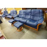 A Norweigan Ekornes Stressless beech and blue leather five piece lounge suite, comprising; two