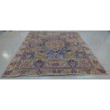 A Persian cream and blue ground rug, 324 x 270cms, a/f