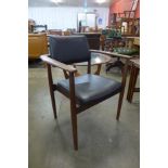 A teak and black vinyl desk chair