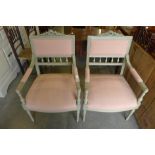 A pair of French painted beech and fabric upholstered fauteuil chairs