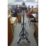 A Victorian Aesthetic Movement wrought iron and copper floor standing oil lamp