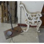 A pair of painted cast iron bench ends and a vintage set of scales