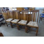 A set of four carved oak dining chairs